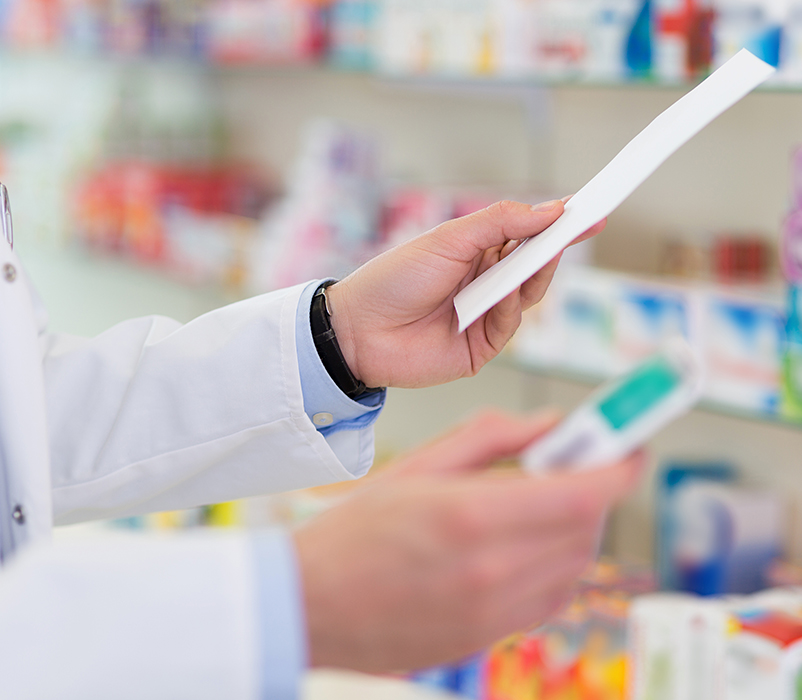 Pharmacist filling prescription in pharmacy