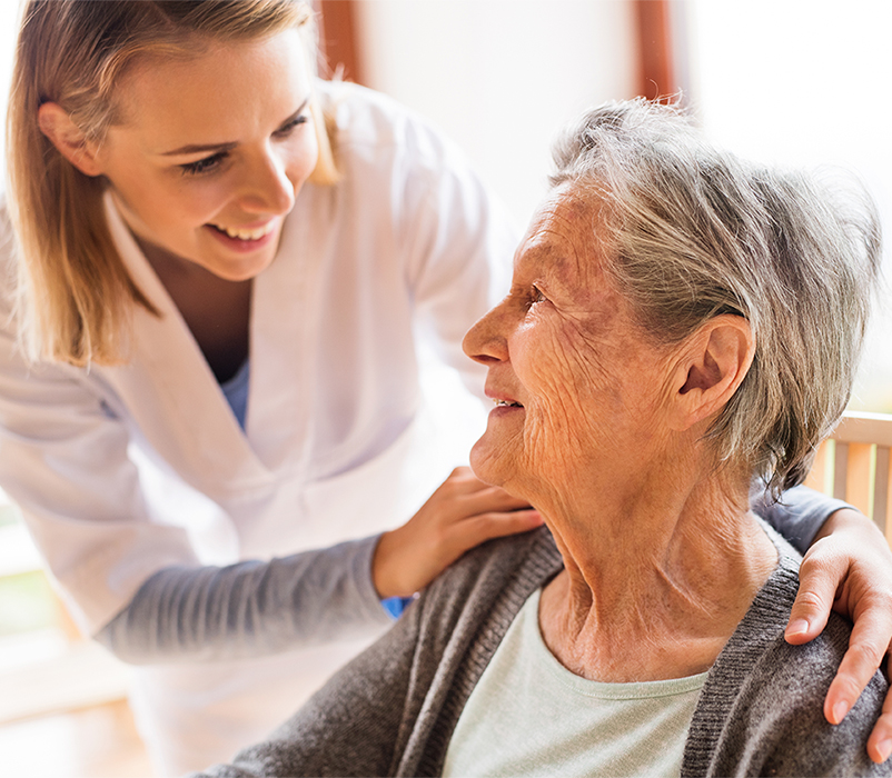 Health visitor and a senior woman during home visit.